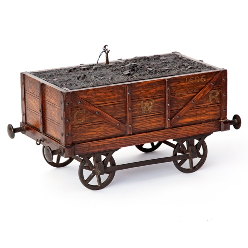 Antique oak smokers cabinet in the form of a GWR coal wagon with cast iron wheels
