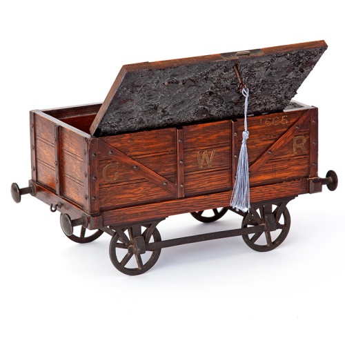 Antique oak smokers cabinet in the form of a GWR coal wagon with cast iron wheels